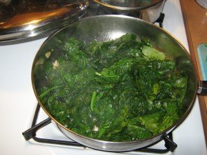 Spinach sautéed in olive oil and garlic to be layered directly from pan into baking dish 