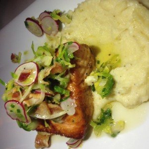 Salmon over parsnip puree and topped with bacon radish salad.