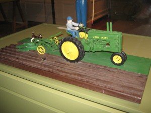 Kelley, who never learned to drive a car or had a license, loved the John Deere tractor; Note the carved dog & bird in this farming vignette 