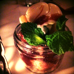 Pecan pie in a jar with vanilla ice cream and mint sprig.