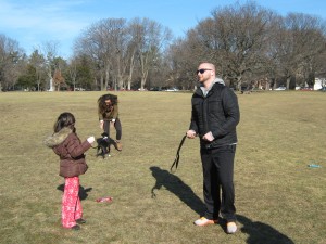 A puppy named Stella, a pit bull & lab mix, off-leash finds a friendly human to greet 