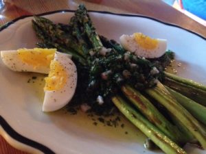 Appetizing oven-roasted asparagus with lovage salsa verde and egg 