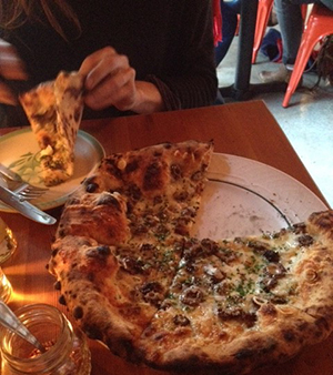 Flavorful pizza of morel mushrooms with ramps, pecorino tartufo and gremolata